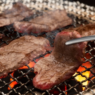 meat on a grill with a tong